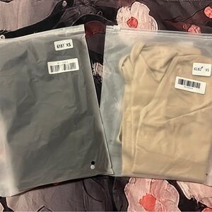 Two brand new XS Hey Shape shapeware  body suits (one is black and one is nude).